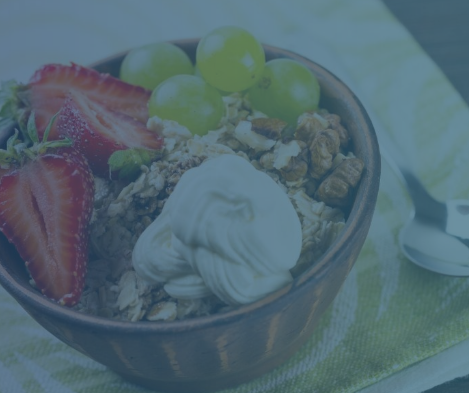 A bowl of muesli cereal piled with fresh fruit and yoghurt.